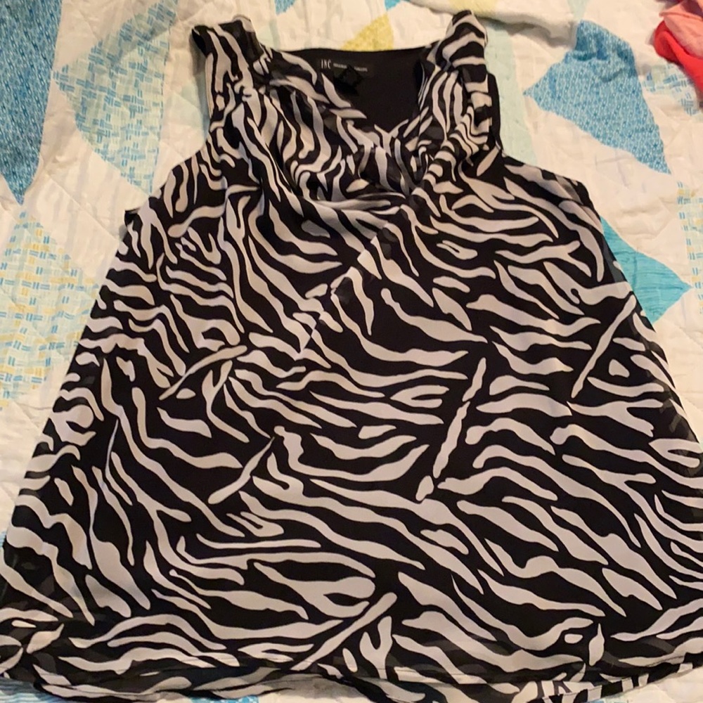 Sleeveless zebra print blouse.